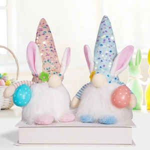 Detail of Easter gnomes with sequined hats and plush bunnies holding colorful eggs