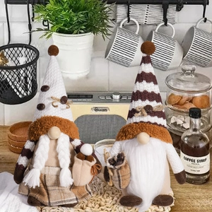 Close-up of coffee gnome plush dolls with knit hats and coffee bean detail