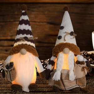 Detail of knitted coffee gnome ornaments with warm LED lights and coffee bean accents