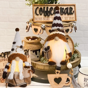Detail of light-up coffee gnomes with warm LED glow and mini coffee bean bags