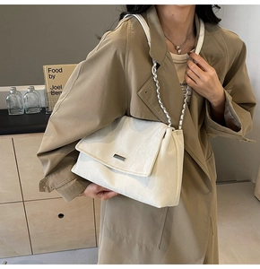 Off-white leather shoulder bag with silver chain strap shown worn by a model