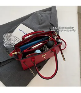 Interior detail of red leather bridal handbag showing large capacity and compartments