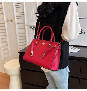 Close-up of elegant red bridal leather handbag featuring gold clasp and buckle detail