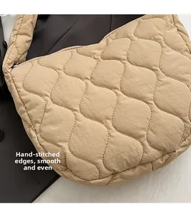 Detailed close-up of ripple-quilted nylon fabric texture and neat handmade stitching