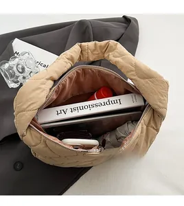 Interior view of beige quilted nylon tote bag showing spacious capacity for books and makeup