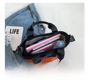Internal view of large capacity tote bag showing compartments for books and tablets