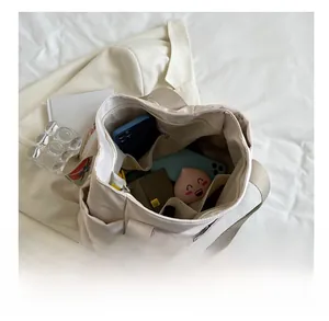 Interior view of nylon tote bag showing spacious multi-compartment storage and patterned strap