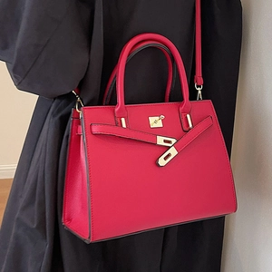 Elegant red leather wedding handbag with a top handle and shoulder strap in Kelly style