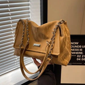 Khaki wrinkled leather tote bag with chain strap and metal flap detail for daily use