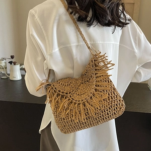 Handmade straw shoulder bag with fringe tassel and woven strap for beach vacation