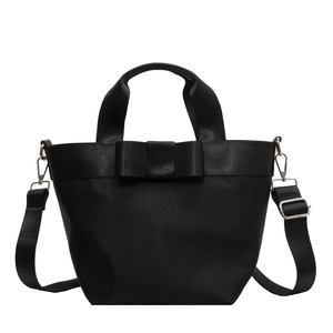 Large black nylon bucket bag with a bow decoration, featuring versatile crossbody straps