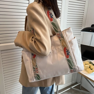 Off-white nylon tote bag with floral embroidered strap for work commute and daily use