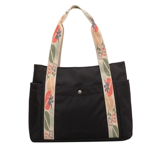 Black nylon tote bag with floral printed handles and side pockets for women commute