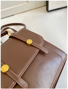 Close-up of vintage brown leather texture and gold metal buckles with fashion engraving