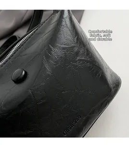 Detail of soft black PU leather texture with wrinkled finish and elegant press stud
