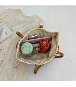 Detail view of woven tote bag interior showing large capacity for umbrella and phone