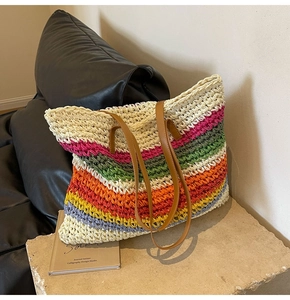 Detailed view of colorful striped crochet tote bag with brown faux leather handles