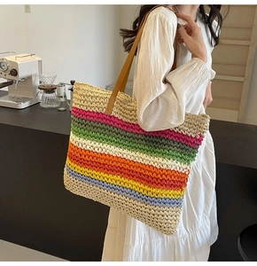Detail of colorful striped woven tote bag with brown faux leather straps for women