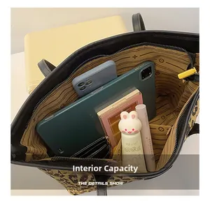 Internal capacity of leopard print tote bag showing storage for tablet and cosmetics