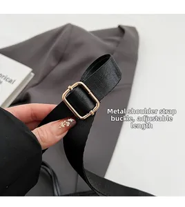 Detail of adjustable black nylon strap with a gold rectangular metal buckle closure