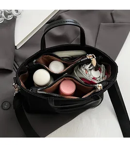 Top view of large black nylon handbag with multiple organized storage compartments
