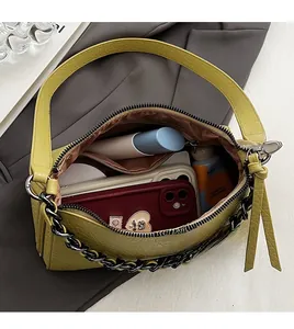 Internal view of a yellow crocodile texture crossbody bag showing spacious compartments