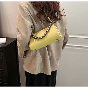 Side view of trendy yellow ruched handbag with thick chunky chain strap decoration