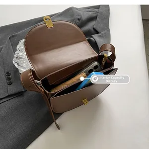 Internal capacity display of vintage brown leather saddle bag with multiple compartments