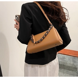 Caramel brown leather crossbody bag featuring a chic black chain strap and litchi texture