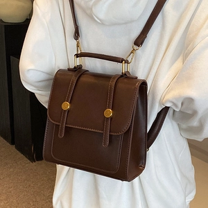 Vintage dark brown faux leather backpack with gold buckles and top handle for women