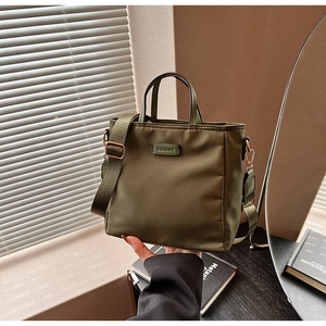Detailed view of the olive green nylon bucket bag with CLEARUK logo and wide strap