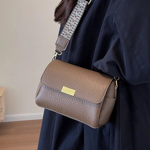 Minimalist brown pebbled leather crossbody bag with vintage woven wide strap and gold buckle