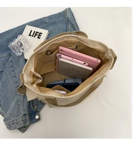 Top view of the spacious canvas tote bag interior showing various pockets and daily essentials