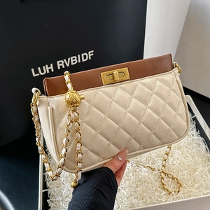 Elegant quilted chain crossbody bag in cream with brown leather trim and gold lock