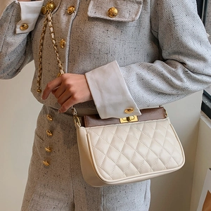Quilted beige and brown crossbody chain bag styled on a tweed outfit for high-end look