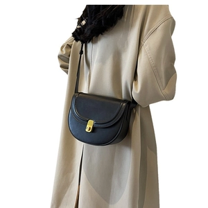 Classic black leather saddle bag with gold swivel lock and elegant shoulder strap