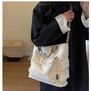Detail of canvas tote bag with multiple pockets and adjustable shoulder strap