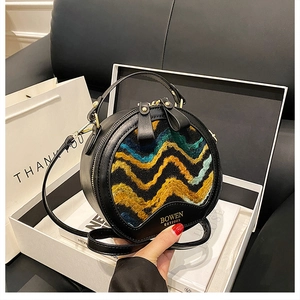 Macro shot of circular round handbag with wave textures in a white gift box