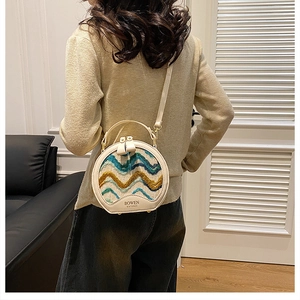 Detail showing the retro wave pattern and leather texture of the round crossbody bag