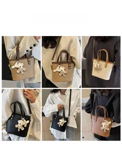 Leather bucket bag with bear pendant shown in four colors via model lifestyle shots