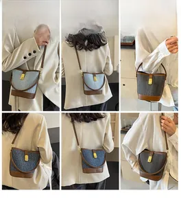 Model lifestyle shots of two-tone bucket bag with textured denim and brown leather trim