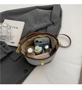Interior view showing the storage capacity of the canvas and leather bucket bag