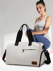 Detail of off-white travel bag showing independent shoe compartment and durable fabric