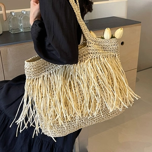 Large bohemian straw tote bag with long tassels for summer beach and vacation style