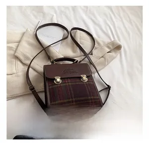 Detail showing vintage British style plaid pattern with retro gold metal buckle clasp