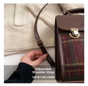 Detail of adjustable shoulder strap on vintage plaid patchwork leather backpack
