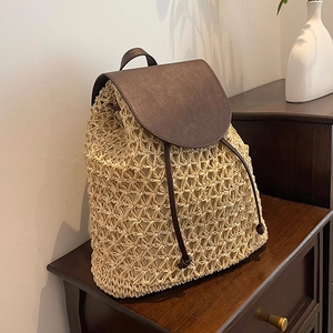 Large straw woven backpack with brown leather flap for summer beach trips and vacations