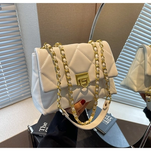 Quilted white chain crossbody bag with golden twist lock and elegant leather strap