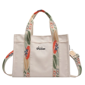 Chic beige canvas tote bag with floral embroidered straps for summer commuting