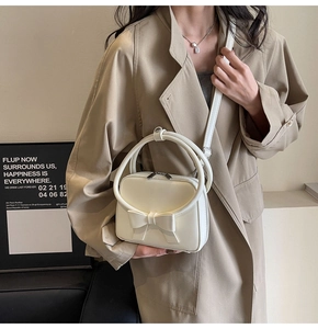 Chic cream white crossbody bag with stylish 3D bow and unique circular top handles